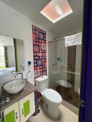 a bathroom with a toilet and a sink and a shower at La posada de Rubi in Salento