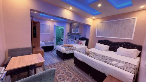 a bedroom with two beds and a couch and a table at Mitra Downtown Hotel in Istanbul