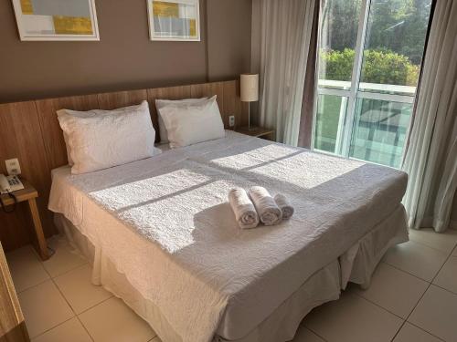 a bedroom with a bed with two towels on it at Rio Stay Residence in Rio de Janeiro