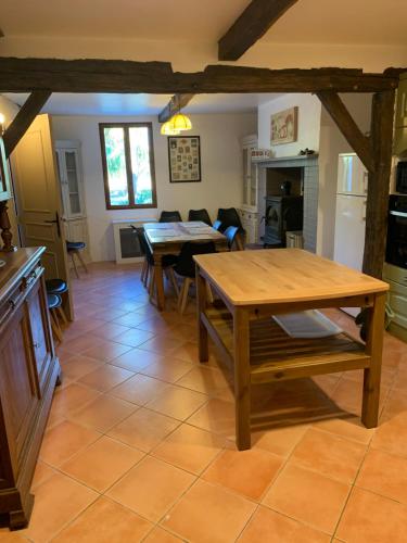 a kitchen and living room with a table and chairs at Lauberge de Nogaro in Caupenne-dʼArmagnac