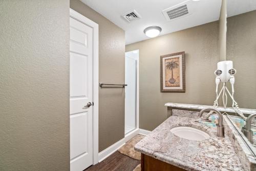 a bathroom with a sink and a mirror at Emerald Dolphin 0640 in Pensacola Beach