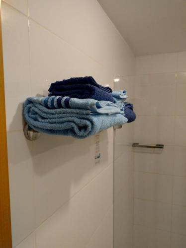 a blue towel is sitting on a shelf in a bathroom at S4 Hotel Águas Claras Brasília Flat particular fora do pool in Brasilia