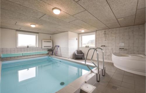 a bathroom with a swimming pool and a tub and a sink at Beautiful Home In Ringkbing With 4 Bedrooms, Sauna And Wifi in Klegod
