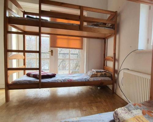 a bedroom with two bunk beds and a window at Хотел на Печерской in Kyiv