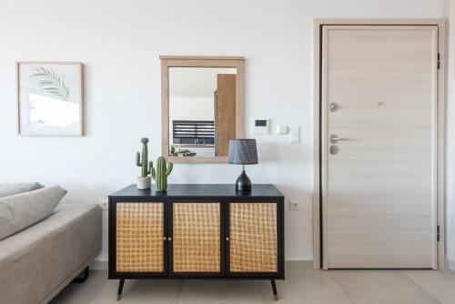 a living room with a bed and a table with a lamp at Aquarama Pool Apartments in Ixia