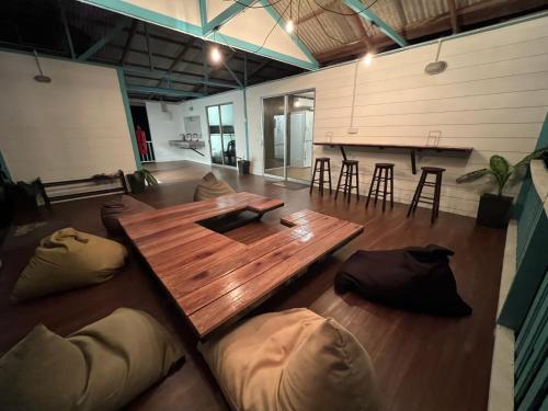a large room with a wooden table and some chairs at Dormitory Pondok in Tioman Island
