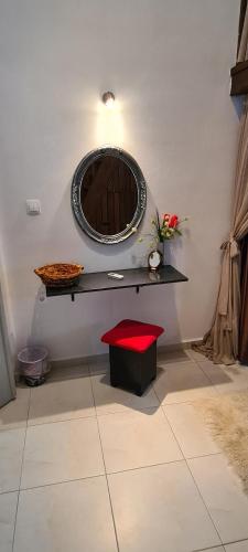 a room with a table with a mirror and a red stool at Diasoulas house in Rhodes Town