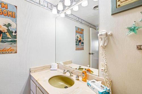 a bathroom with a sink and a mirror at Sand & Sea: Coastal Cove (518) in Seaside