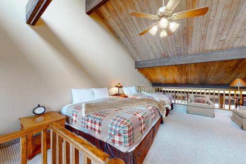 a bedroom with a bed and a ceiling fan at Tamarron Lodge Escape in Durango