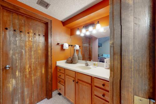 a bathroom with a sink and a mirror at Tamarron Lodge Escape in Durango