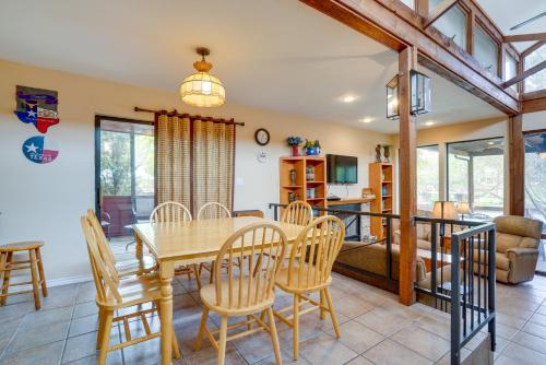 a dining room and living room with a table and chairs at Deck and Gas Grill Riverfront McQueeney Duplex in McQueeney