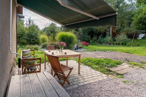 a wooden table and chairs on a patio at Apartmán v podzámčí in Rychnov nad Kněžnou