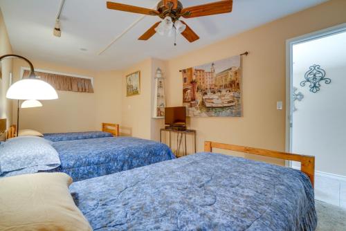 a bedroom with two beds and a ceiling fan at Deck and Gas Grill Riverfront McQueeney Duplex in McQueeney
