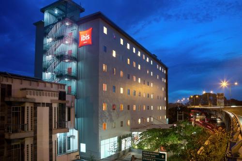 a building with a sign on the side of it at Ibis Bandung Pasteur in Bandung