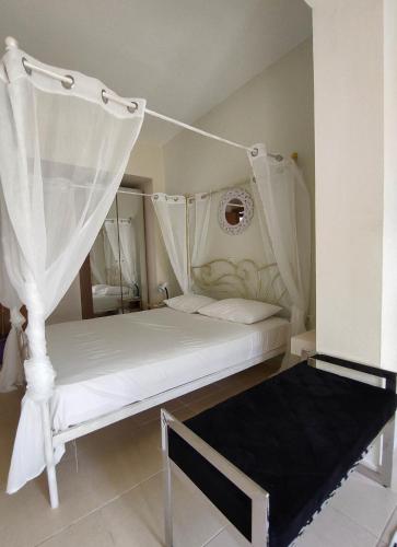 a bedroom with two beds with white drapes at Villa Despina 2 Plakias Private Villa, Private Swimming Pool Garden, Panoramic Sunset in Asómatoi
