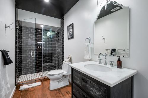 a bathroom with a sink and a toilet and a shower at Luxe Rock Bungalow in the Heart of Hollywood in Los Angeles