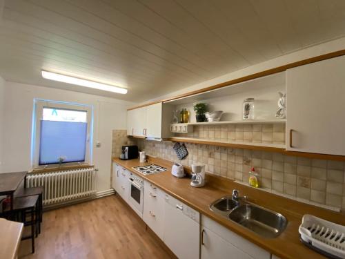 a kitchen with a sink and a counter top at Ferienhaus SüMeer in Wilhelmshaven