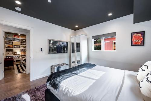 a bedroom with a large bed and a dining room at Luxe Rock Bungalow in the Heart of Hollywood in Los Angeles