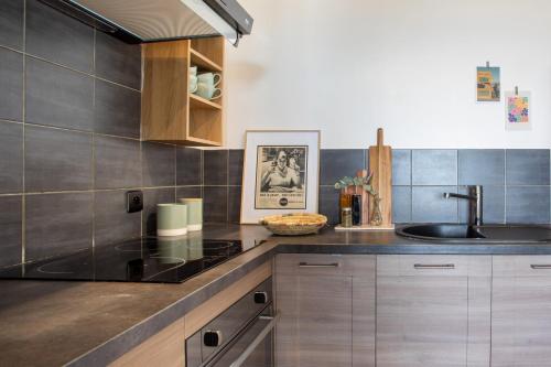 a kitchen with a sink and a counter at Vue mer, terrasse et parking privé in Antibes