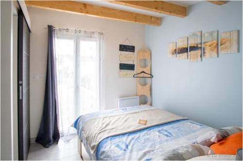 1 dormitorio con cama y ventana en "Le Pírate benèze"gîte insolite,situation idéale,accueil attentionné, en Trizay