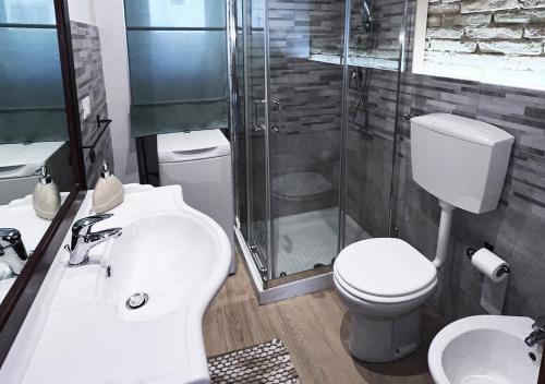a bathroom with a shower and a toilet and a sink at Casa Vacanze La Graziella - LO CHALET in Ferrandina