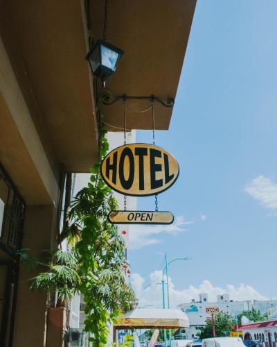 a sign for a hotel is hanging from a building at Casa Chetumal Hotel in Chetumal