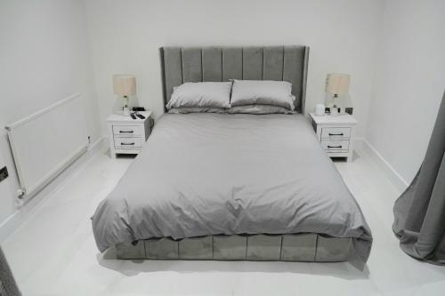 a bedroom with a large bed and two night stands at Phoenix Heights in London