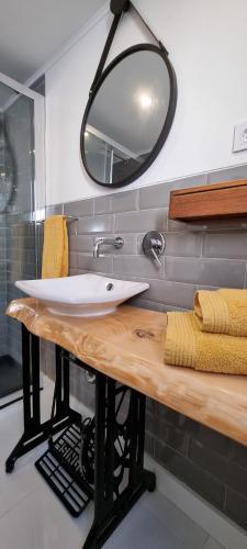 a bathroom with a sink and a mirror at Family Surf Home - Casa do Páteo 5 in Santo Isidoro