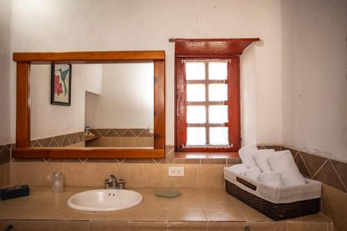 a bathroom with a sink and a mirror at Cabaña Filiberta de Lucas 
