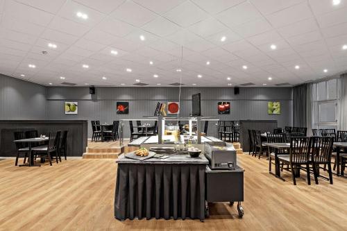 a large room with tables and chairs in it at Best Western Tingvold Park Hotel in Steinkjer