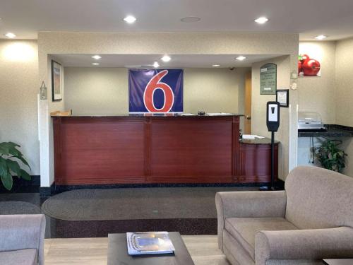 a waiting area of a hospital with a large wooden wall at Motel 6 East Windsor, NJ Hightstown in East Windsor