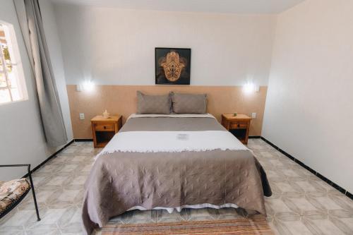 a bedroom with a large bed and two night stands at Hotel Fazenda Bona Espero in Alto Paraíso de Goiás