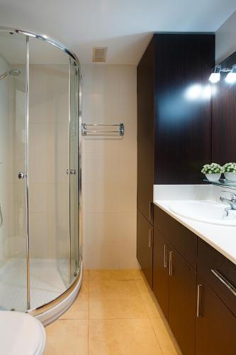 a bathroom with a glass shower and a sink at Port de Xabia I in Jávea