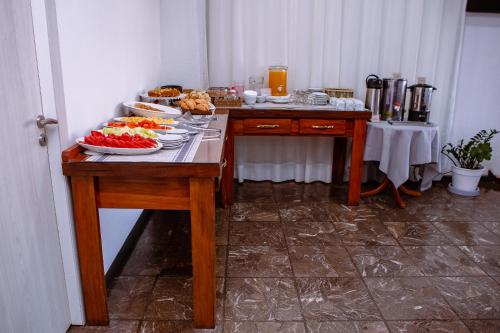 a table with plates of food on top of it at Tajy Iguazu Hotel in Puerto Iguazú
