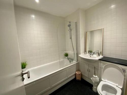 a bathroom with a toilet and a sink at Sanctuary Spaces at The Shard with private parking in London