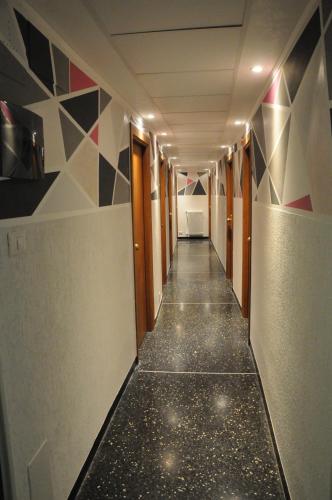 a hallway with a tile floor and a corridorngthngthngthngth at Hotel Villa Camilla in Varazze