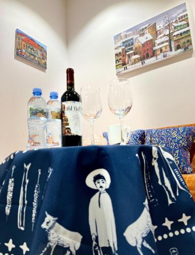a table with two wine glasses and a table cloth at Room 42 in Tbilisi City