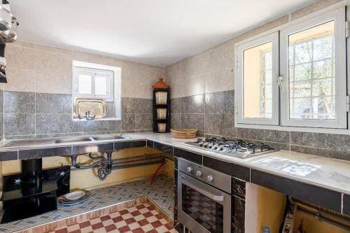 a kitchen with a sink and a stove at Gîte Nature in Azrou