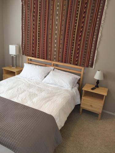 a bedroom with a bed with a large headboard at The Point - On Gull Lake in Brainerd