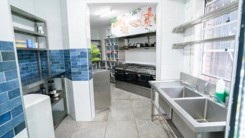 a kitchen with a sink and a stove at Mad Monkey Downtown in Sydney
