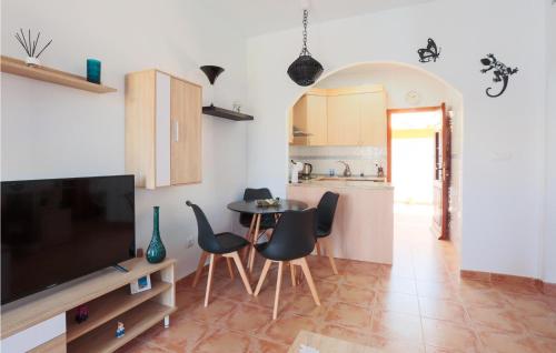 a living room with a tv and a table and chairs at Bluemoon 2 in Mazarrón