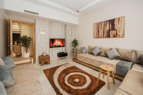 a living room with a couch and a fireplace at Next Home - Airport in Nouaseur