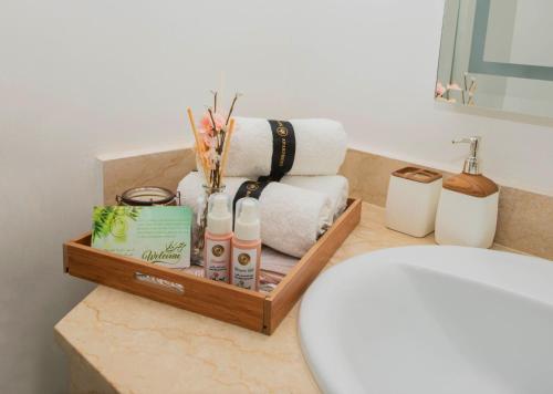 a bathroom with a toilet and towels on a counter at Luxury Apartment Airport in Nouaseur