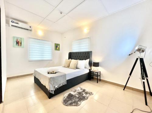 a bedroom with a bed with a camera on a tripod at The EDEN in Lagos