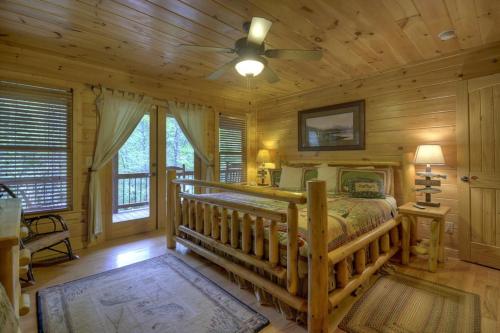 a bedroom with a bed and a ceiling fan at Go Fish- Fightingtown Creek Frontage in McCaysville