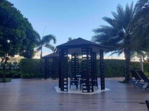 a gazebo with chairs and tables in a park at 1BR Condo Unit by Nartleb Staycation in Manila