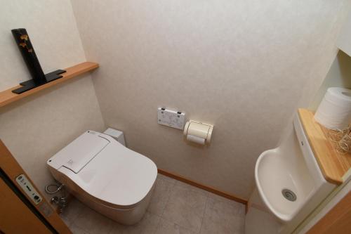 a small bathroom with a toilet and a sink at 宿樽 in Kanazawa