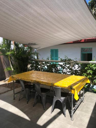 a picnic table with a yellow table cloth on it at The Hideway in Noumea