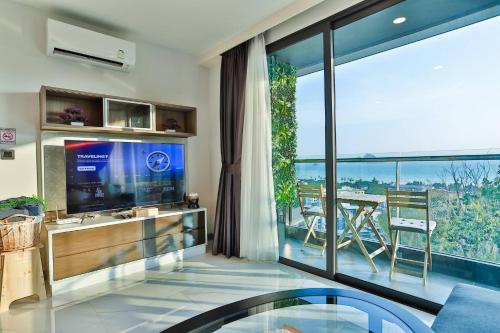 a living room with a tv and a large window at A503-Penthouse Amazing View 2brs3bedsAo Nang Beach Center in Ao Nang Beach