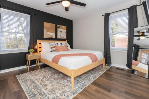 a bedroom with a bed and a ceiling fan at 3 Mi to City & Pet Friendly & Quiet Neighborhood in Charlotte
